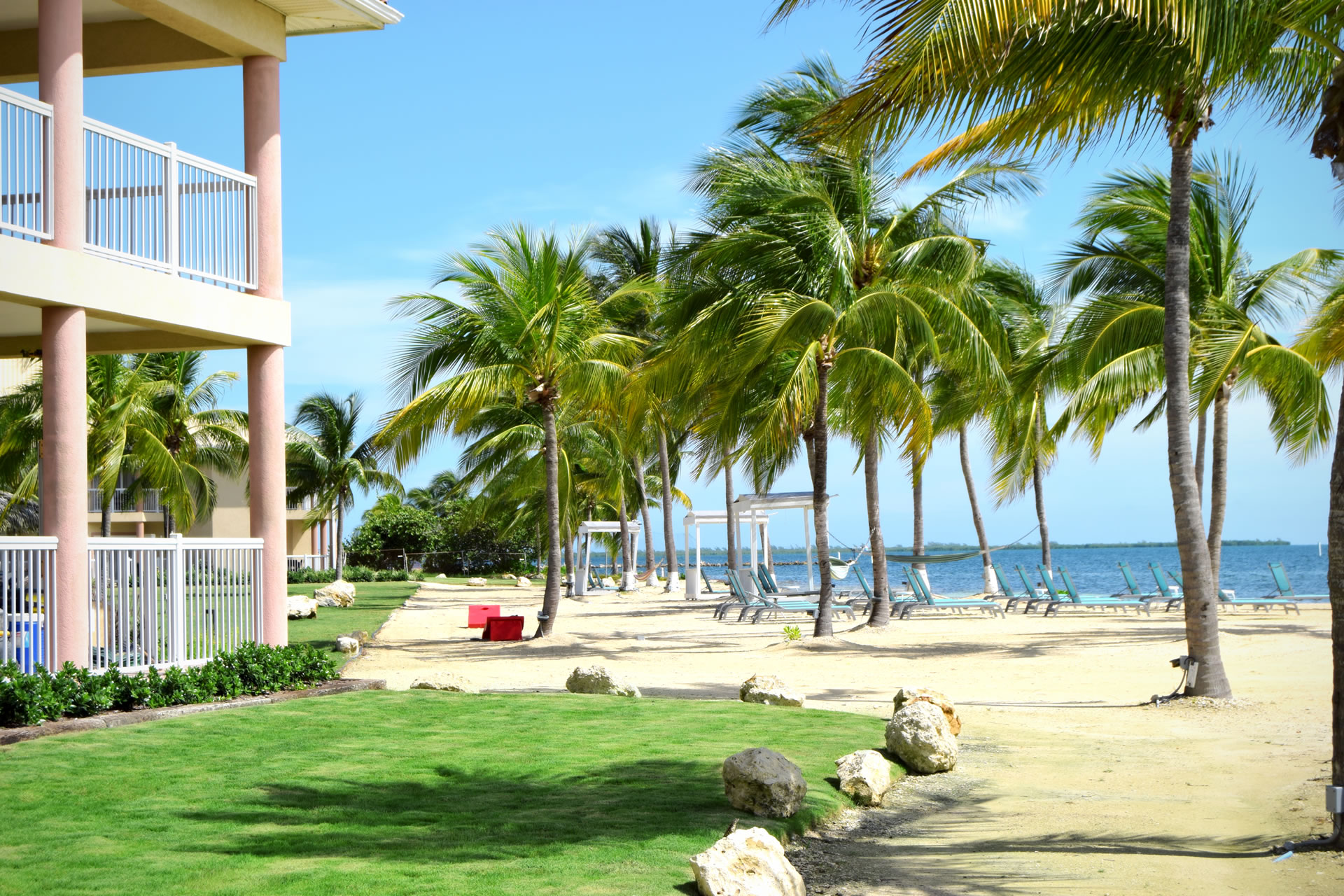 View of palm trees lining the beach at Grand Caymanian Resort.