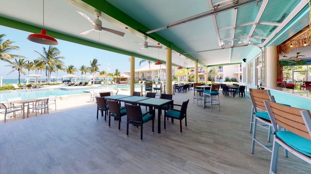 Open air dining patio of the Driftwood Bar and Grill at the Grand Caymanian Resort.