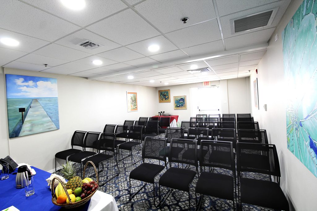 Meeting space at the Grand Caymanian Resort configured in a theater layout with an exit door at the back of the room.