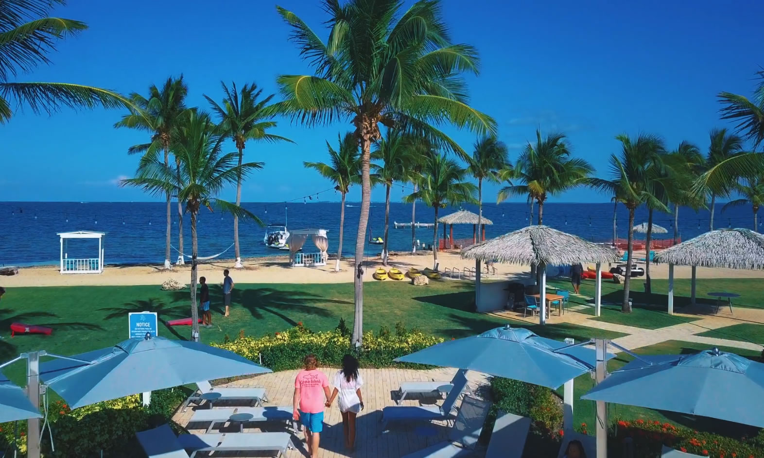 View of the Grand Caymanian Resort beach and pool deck looking towards the North Sound.