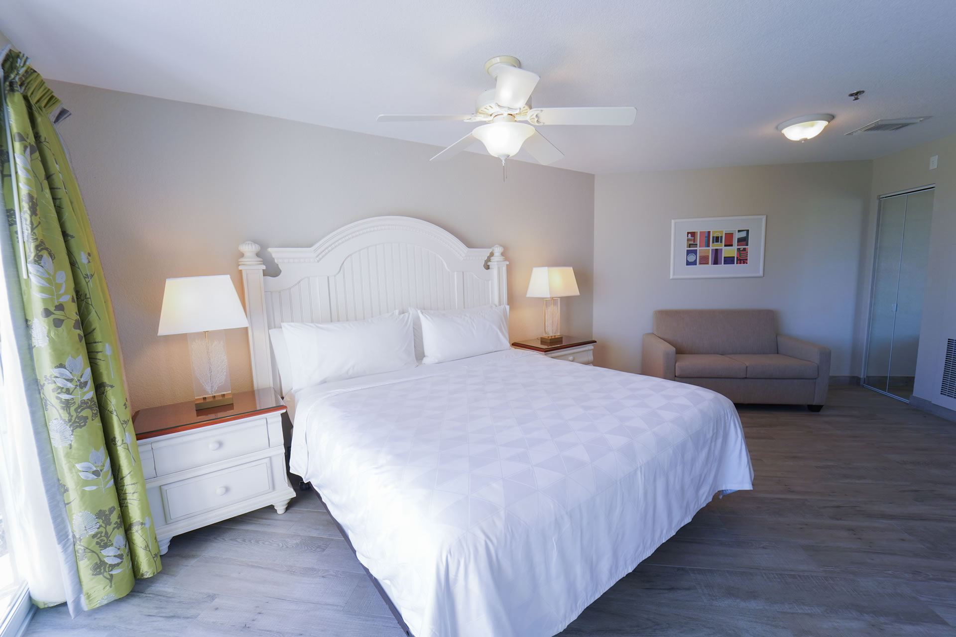 A queen bed and sleeper sofa in the One Queen Bed Studio Suite with a Sleeper Sofa at the Grand Caymanian Resort.