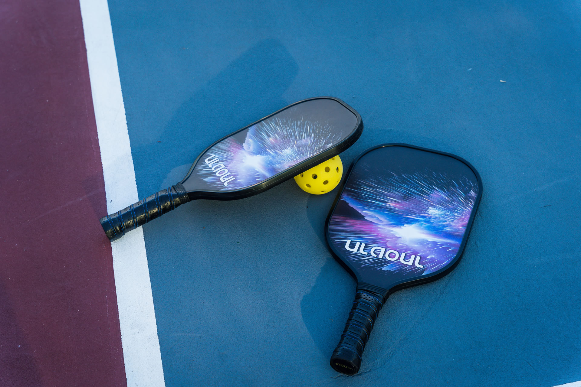 Pickleball paddles and ball at the Grand Caymanian Resort.
