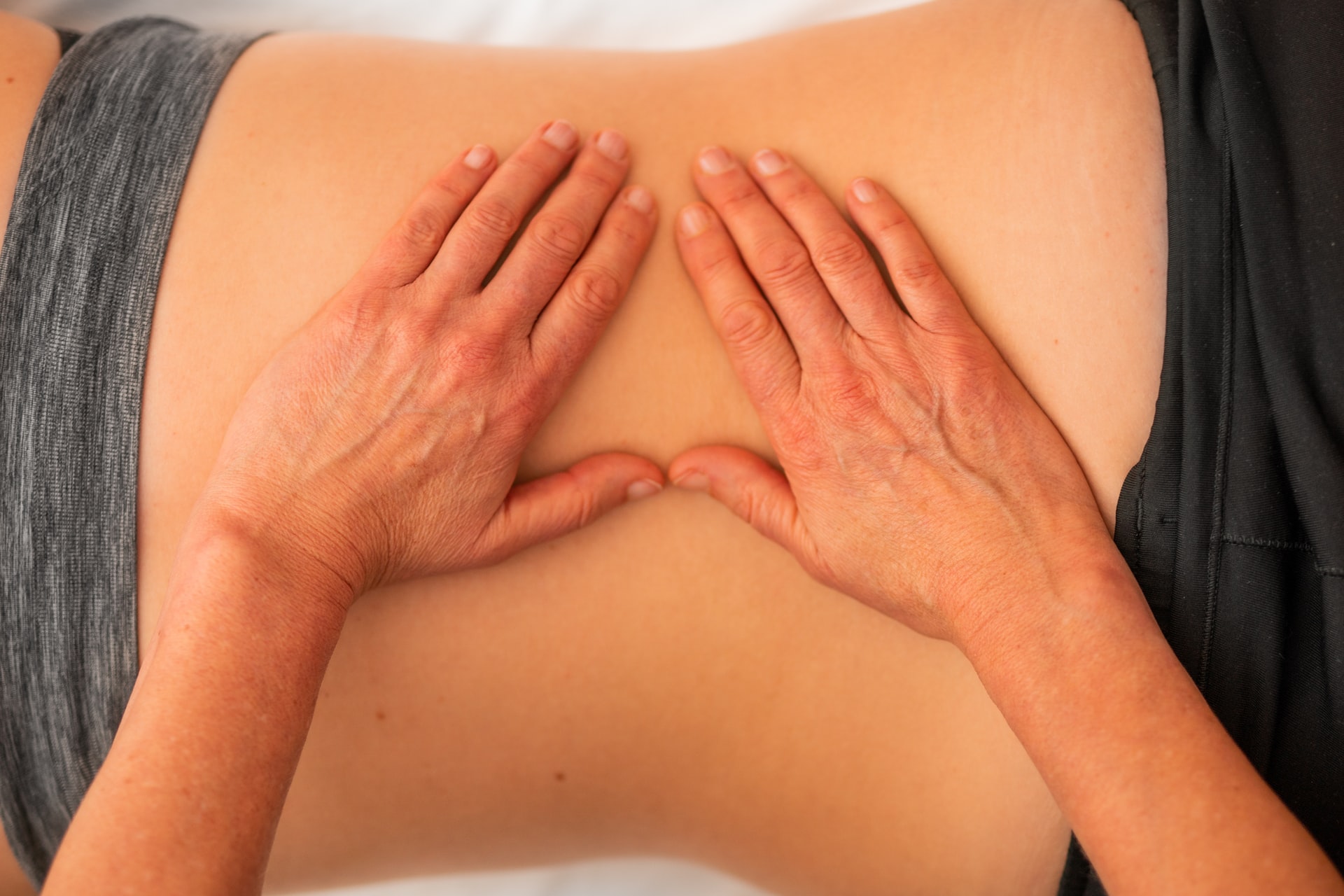 A masseuse massaging a customer's back.