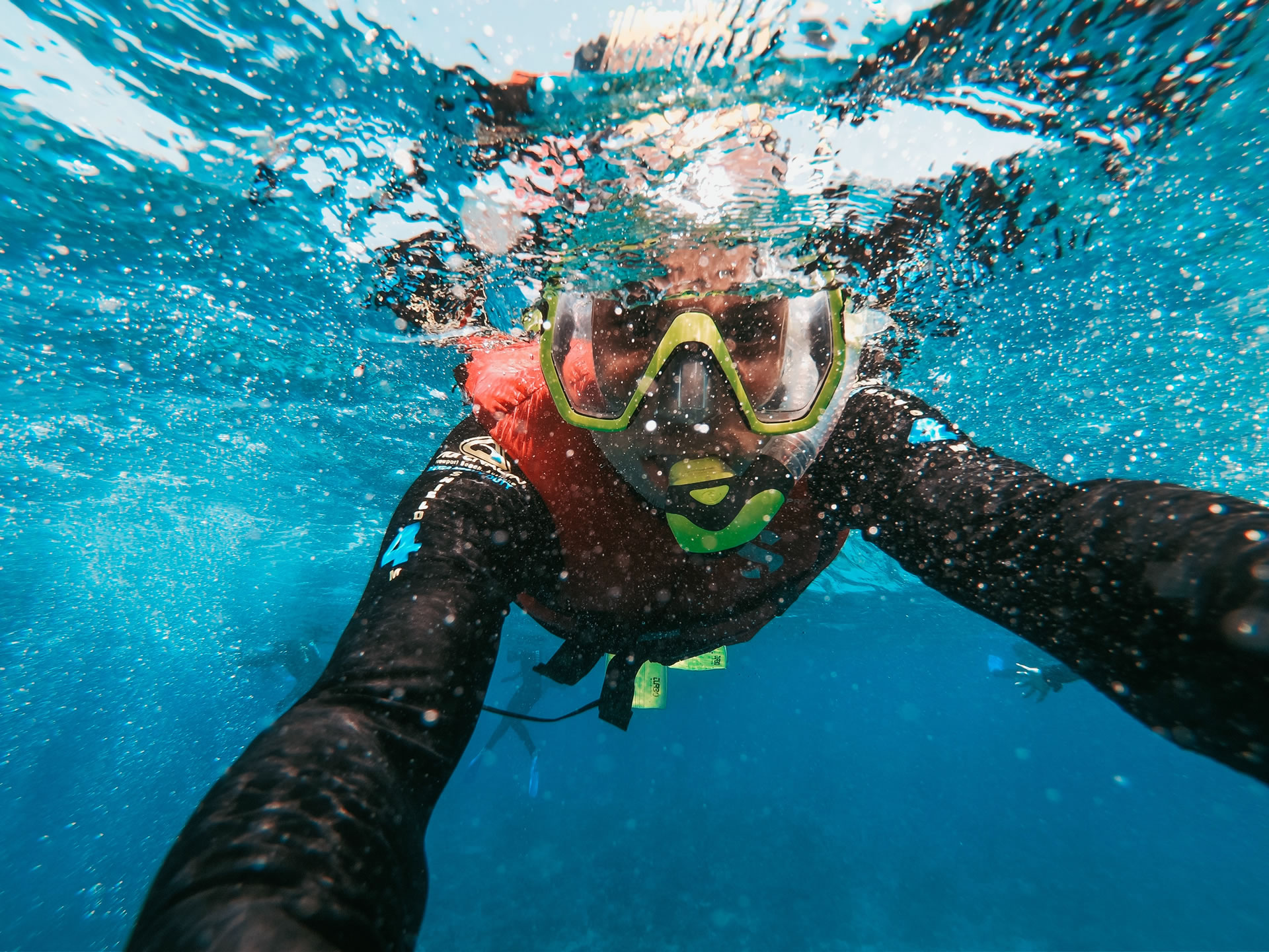 An underwater close-up of a person snorkeling.